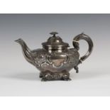 A Victorian silver teapot with hinged lid and flower finial, the compressed circular body embossed