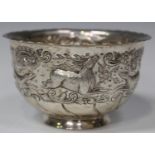 A late Victorian silver bowl, chased with a stag, two hunting dogs and two ducks within a band of