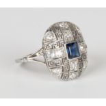 A gold, sapphire and diamond oval panel shaped ring, mounted with a square cut sapphire within a