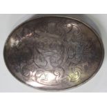 An 18th century silver oval tobacco box and cover, the cover engraved with a monogram framed by a