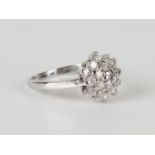 An 18ct white gold and diamond cluster ring, mounted with circular cut diamonds, detailed 'Dia 075',