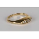 A gold and diamond five stone ring, mounted with a row of graduated cushion shaped diamonds in a