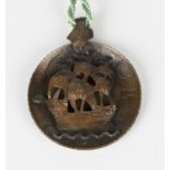 A copper disc shaped pendant in an Arts & Crafts inspired design of a three masted sailing galleon