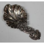 A Victorian silver caddy spoon of rococo scroll moulded form, Sheffield 1857 by Martin Hall & Co,