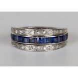 A platinum, sapphire, ruby and diamond swing eternity ring, the central band mounted with a row of