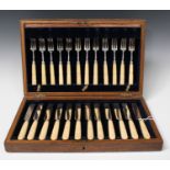 A set of twelve George IV silver fruit knives and forks with carved ivory handles, Sheffield 1824 by