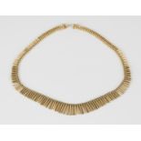 An 18ct gold graduated fringe necklace on a snap clasp, length 46cm.Buyer’s Premium 29.4% (including