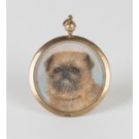 A gold mounted circular pendant locket, detailed '9ct', glazed with a painted portrait miniature