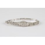 A gold, 9ct white gold and diamond bracelet, the front in a curved panel design, mounted with