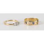 A gold and diamond three stone ring, claw set with a row of cushion shaped diamonds with the