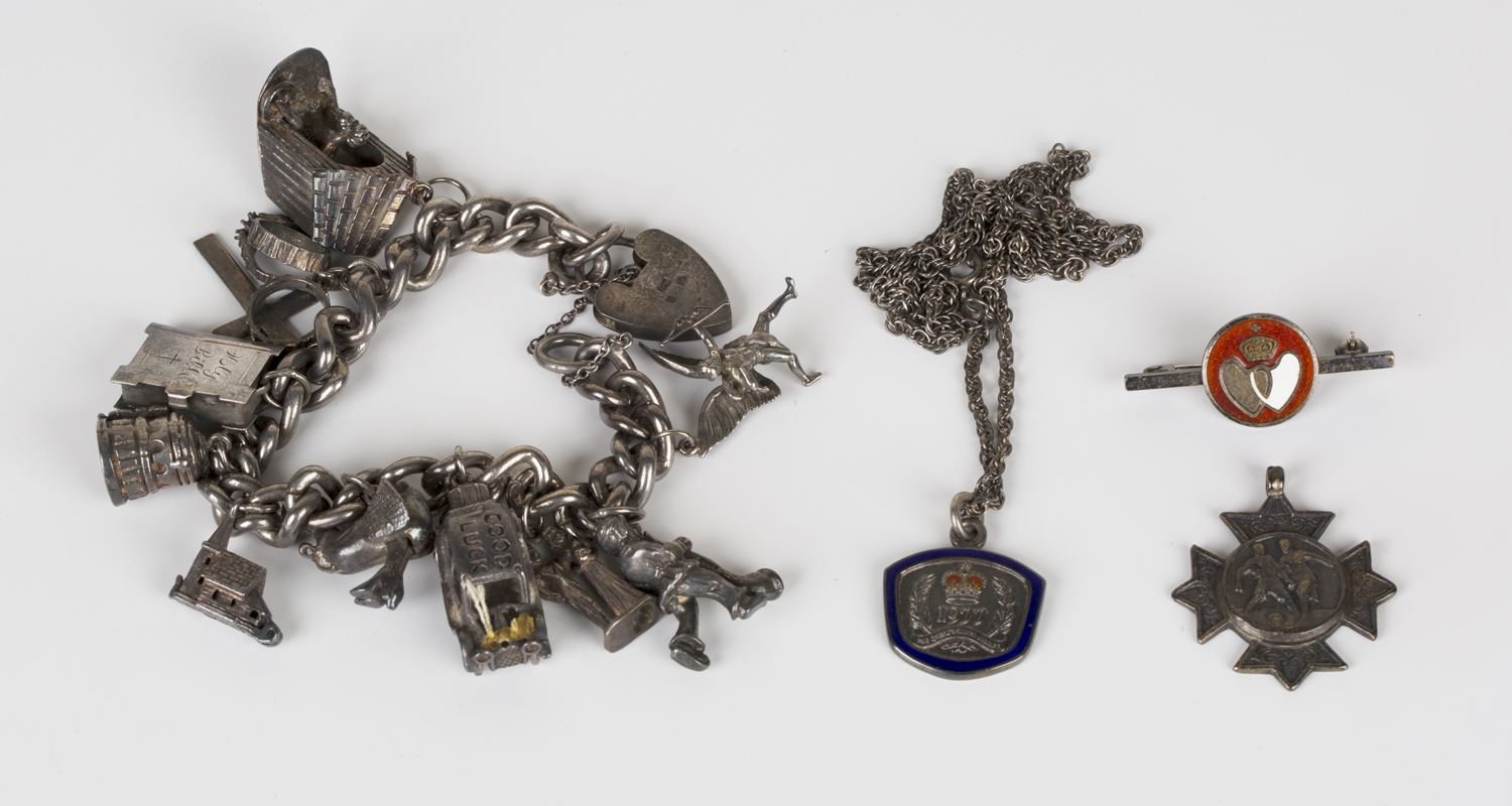 A group of silver jewellery, comprising a curblink charm bracelet, fitted with a variety of