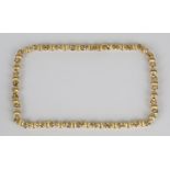 An 18ct gold necklace in a circular and textured bead link design, on a sprung hook shaped clasp,