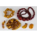 A single row necklace of reconstituted graduated oval cherry coloured amber beads, a single row