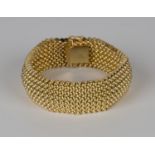 A gold bracelet in a curved multiple link design, on a snap clasp, detailed '750', length 20cm.