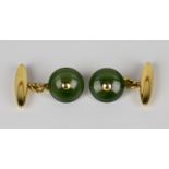 A pair of 9ct gold and nephrite cufflinks with circular nephrite fronts and 9ct gold torpedo