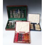 A collection of assorted plated cutlery, including three cased canteens and a set of fish knives and