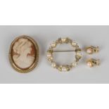 A 9ct gold mounted oval shell cameo brooch, carved as a portrait of a lady within a pierced wirework