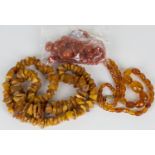 A single row necklace of graduated oval vari-coloured semi-translucent amber beads, a single row
