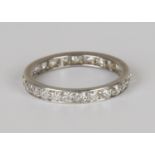 A platinum and diamond eternity ring, set with circular cut diamonds, ring size approx M1/2, total