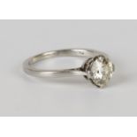A platinum and diamond single stone ring, claw set with a circular cut diamond, ring size approx