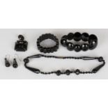 A collection of Victorian black mourning jewellery, including some jet pieces, comprising a pair