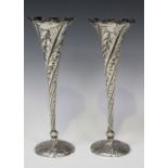 A pair of late Victorian silver specimen vases, each tapering spiral reeded body decorated with