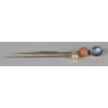 A gold and moonstone stickpin, a gold, coral and diamond stickpin and an imitation pearl stickpin,