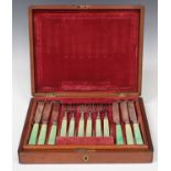 A set of Victorian silver and green stained ivory handled fruit knives and forks, comprising
