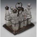 A George III silver cruet stand with central scroll handle and pierced frame, on a rectangular