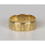 An 18ct gold wide band decorated wedding ring, London 1972, ring size approx L.Buyer’s Premium 29.4%