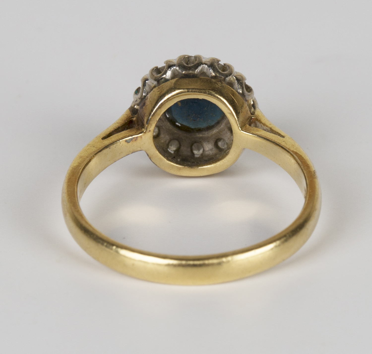 A gold, sapphire and diamond circular cluster ring, claw set with a circular cut sapphire within a - Image 2 of 2