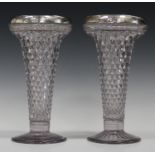A pair of George V silver mounted glass vases of flared trumpet shape with overall moulded diamond