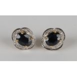 A pair of 9ct gold, sapphire and diamond shaped oval earstuds, each claw set with an oval cut