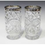 A pair of George V silver mounted cut glass vases, each with silver rim on a circular foot,