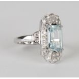 An 18ct white gold, aquamarine and diamond ring, claw set with a rectangular cut aquamarine within a