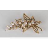 A 9ct gold and cultured pearl brooch, designed as a foliate spray, with a case.Buyer’s Premium 29.4%
