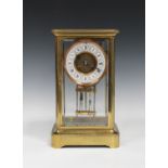 A late 19th/early 20th century lacquered brass four glass mantel clock with eight day movement