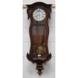 A late 19th century walnut cased Vienna style wall clock with eight day movement striking on a gong,
