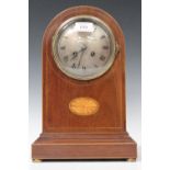 An Edwardian mahogany mantel clock with French eight day movement striking on a gong, the silvered