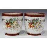 A pair of French porcelain cachepots, late 19th century, of typical U-shape, painted with flowers