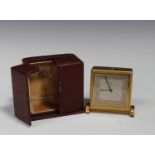 A Zenith gilt brass cased bedside alarm clock with eight day movement, the signed silvered dial with