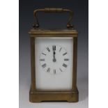 An early 20th century French brass cased carriage clock with eight day movement striking on a