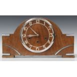 An Art Deco walnut cased mantel clock with chiming movement, the case with chrome mounts and