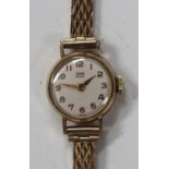 A Tudor Royal 9ct gold circular cased lady's wristwatch with a signed jewelled movement, the