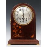 An early 20th century mahogany mantel clock with German eight day movement striking on two gongs,