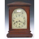 An early 20th century German mahogany cased mantel clock with eight day movement chiming on gongs,