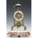 A late 19th century brass skeleton clock with single fusee movement striking on a bell, the silvered