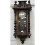 A late 19th/early 20th century walnut cased Vienna style wall clock with eight day movement striking
