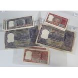 A collection of Indian banknotes, including two Reserve Bank of India one hundred rupees and a