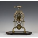 A late Victorian brass skeleton clock with single fusee movement striking hours on a bell, the
